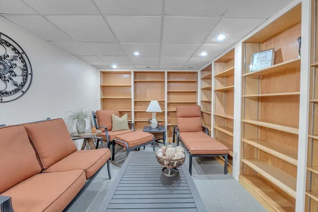 a reading room with furniture and a rug