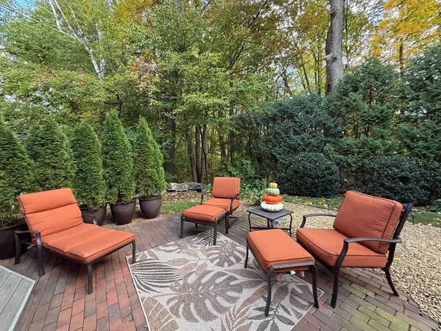 a group of chairs sitting in a roof deck with a table and chairs