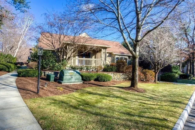a view of a house with a yard patio and fire pit