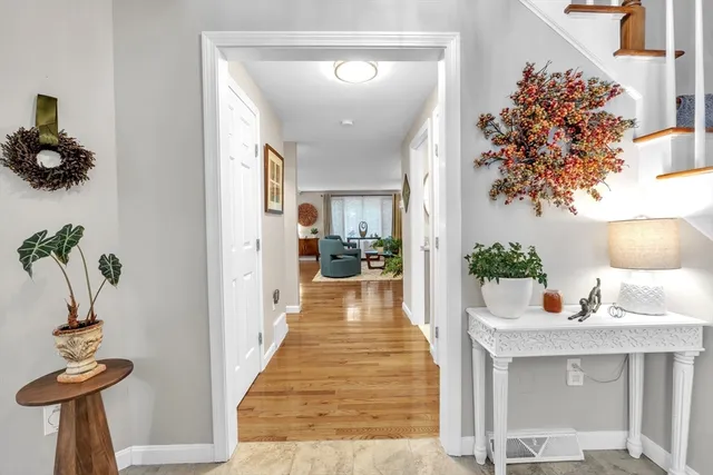 a view of a hallway to a livingroom with furniture and a couch