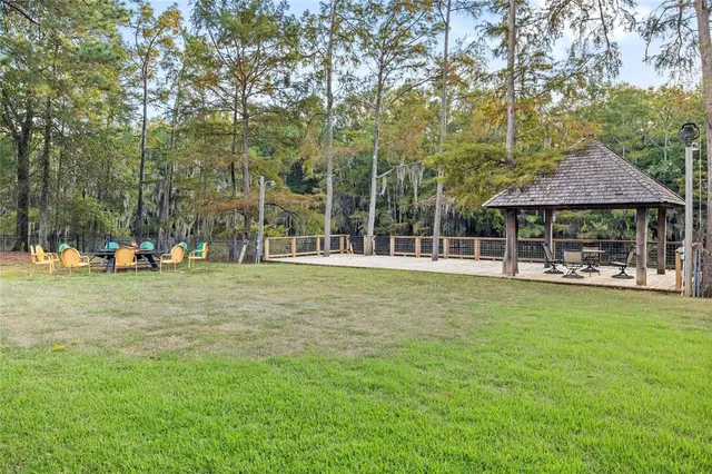 a view of a house with backyard porch and sitting area