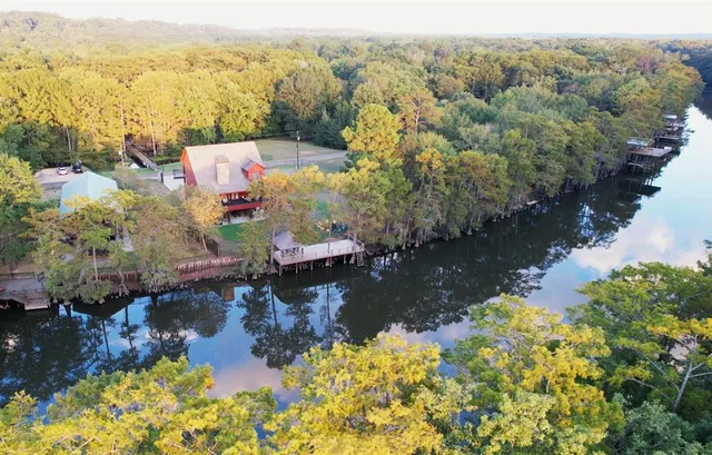a aerial view of a house with a yard lake view and mountain view