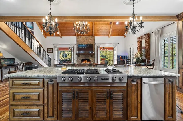 a kitchen with a stove and a chandelier