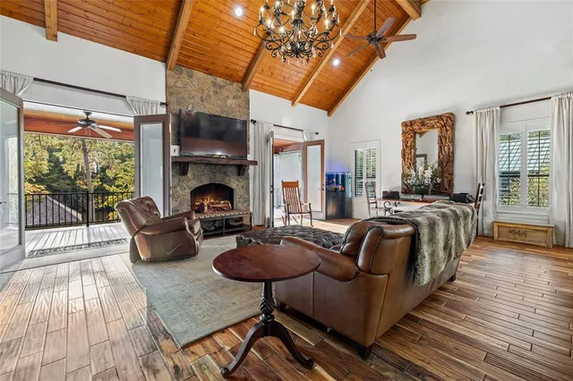 a living room with furniture fireplace and wooden floor