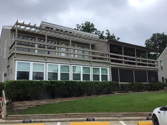 a front view of a building with a garden