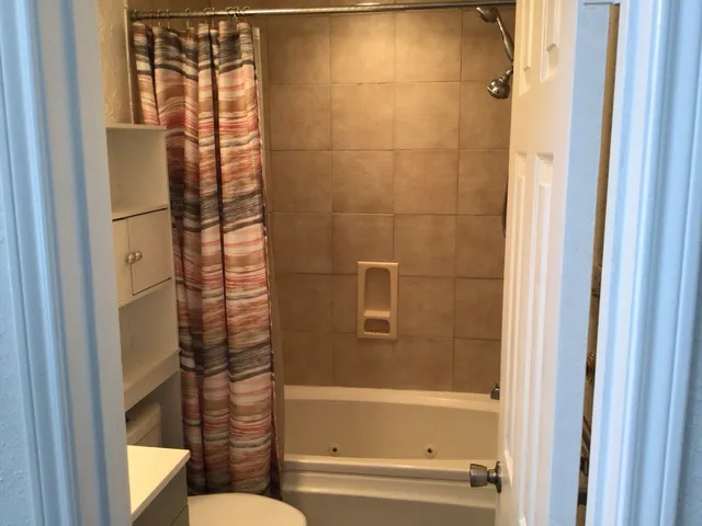 a bathroom with a bathtub and a shower