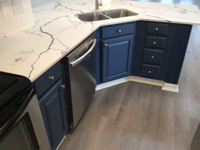 a kitchen with a sink and wooden cabinets