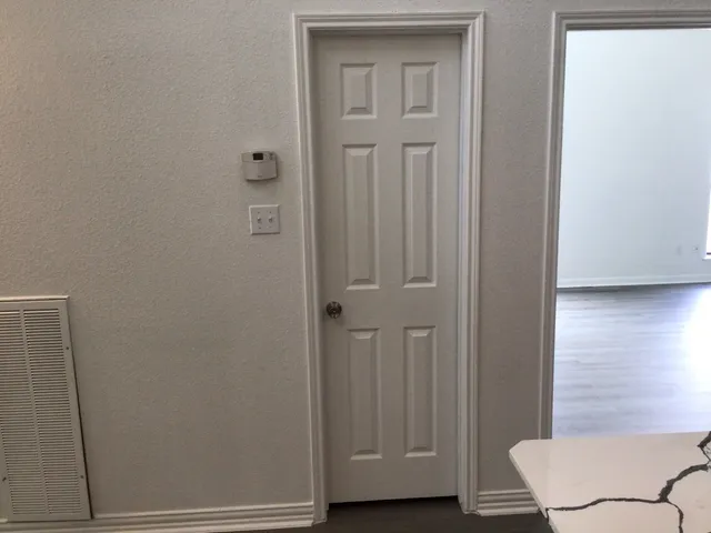 a view of a hallway with wooden floor