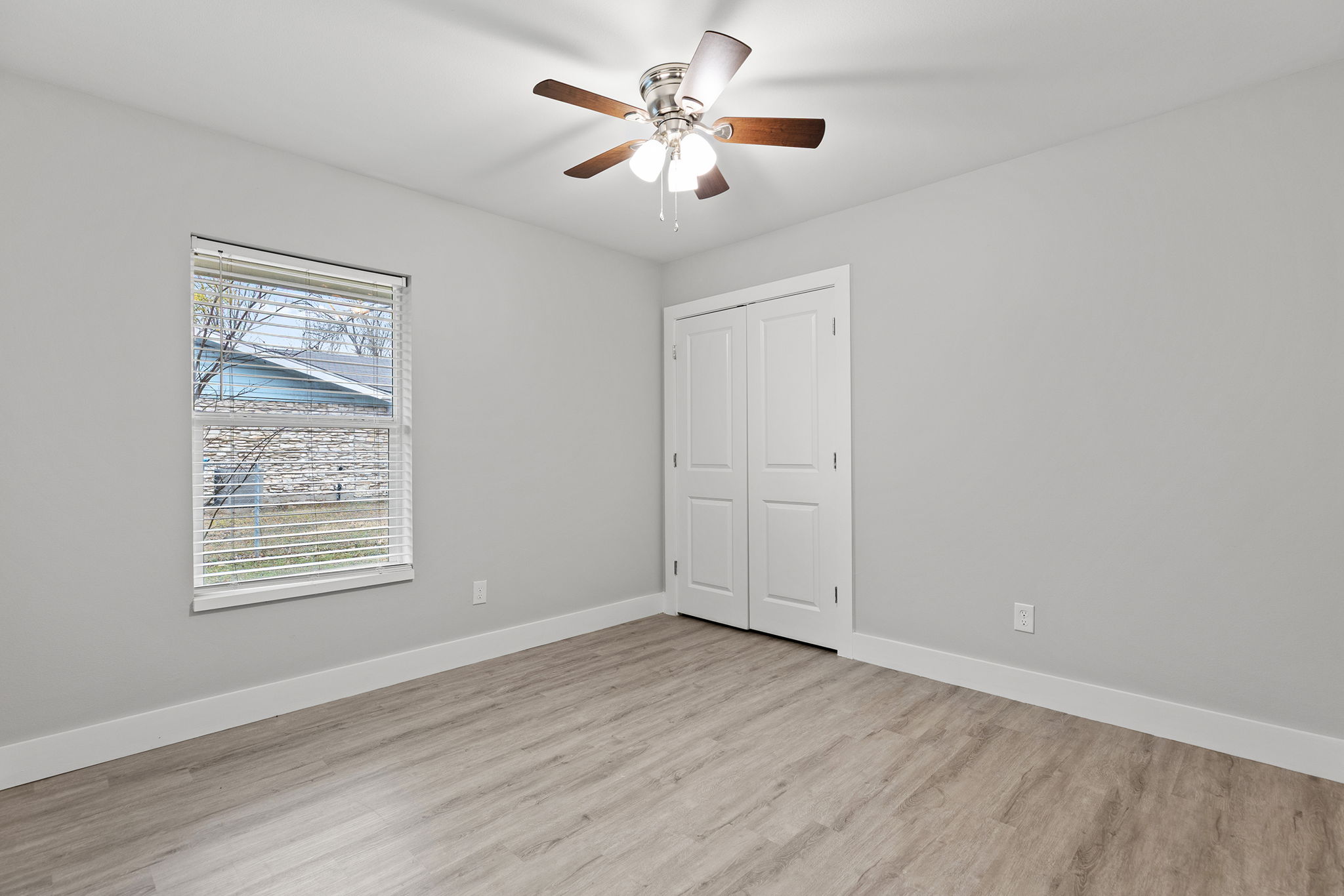 813 Central Avenue Elgin, TX 78621 - Photo 15 of 22 Unfurnished bedroom featuring light wood-style flooring, a closet, and ceiling fan