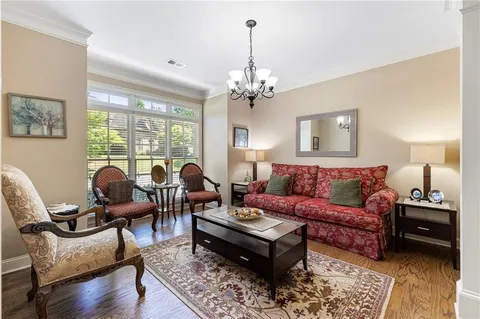 a living room with furniture fireplace and a large window