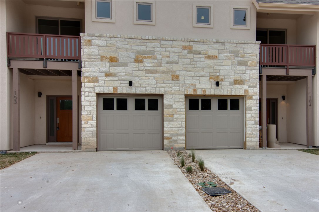 a front view of a house with garage