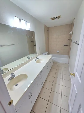 a bathroom with a double vanity sink and mirror