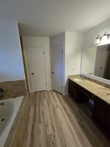 a spacious bathroom with a sink and a granite counter tops