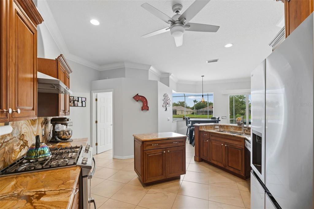 11808 Soft Rush Terrace Lakewood Ranch, FL 34202 - Photo 24 of 71 a kitchen with stainless steel appliances granite countertop a stove and a refrigerator