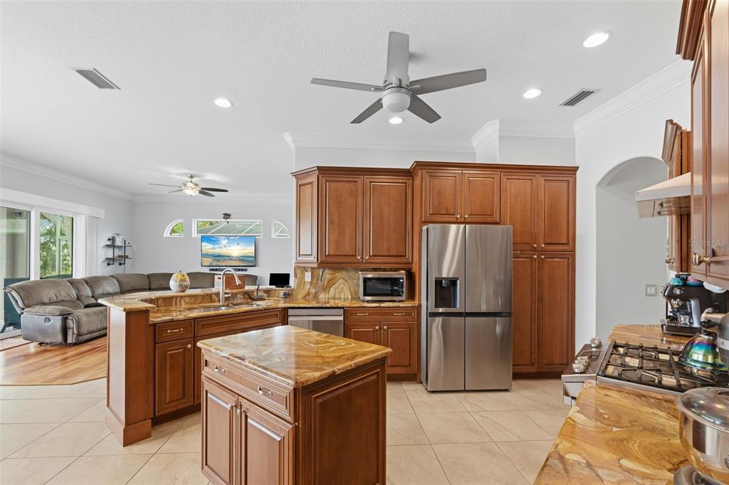 11808 Soft Rush Terrace Lakewood Ranch, FL 34202 - Photo 26 of 71 a kitchen with stainless steel appliances granite countertop a refrigerator stove and sink