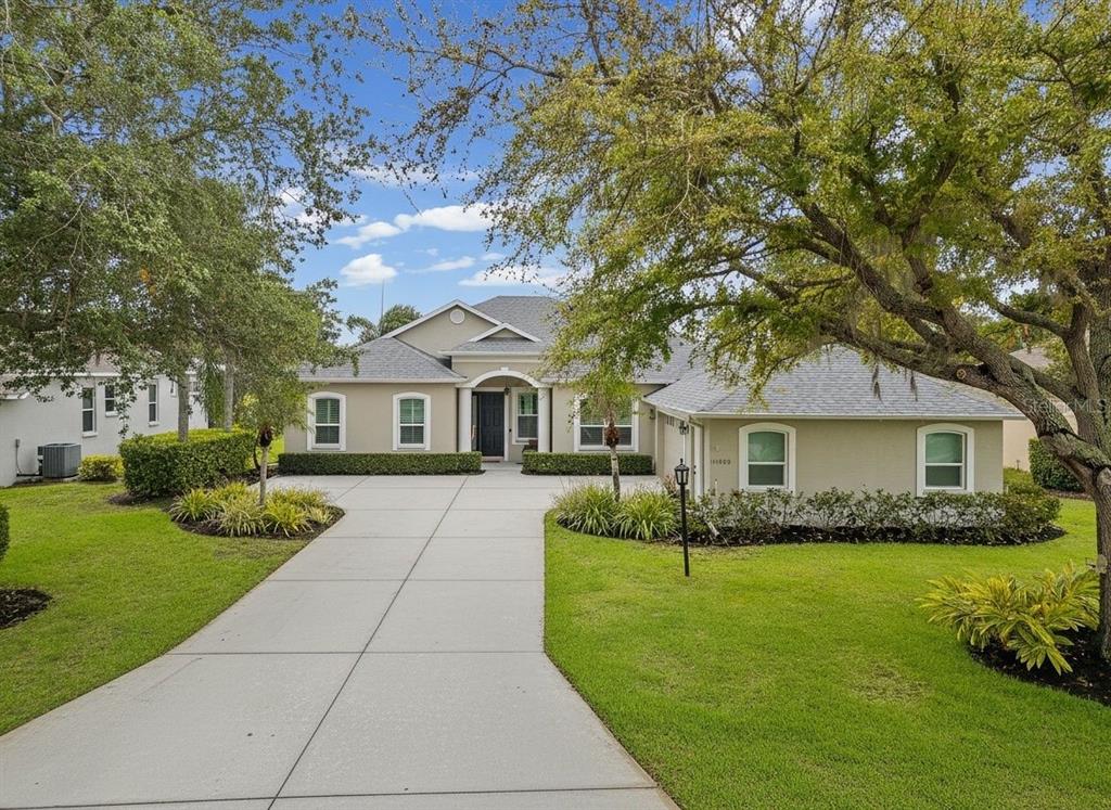 11808 Soft Rush Terrace Lakewood Ranch, FL 34202 - Photo 3 of 71 a front view of a house with garden