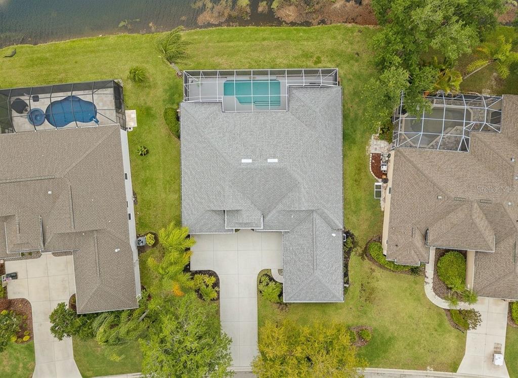 11808 Soft Rush Terrace Lakewood Ranch, FL 34202 - Photo 71 of 71 an aerial view of a house with swimming pool and large trees