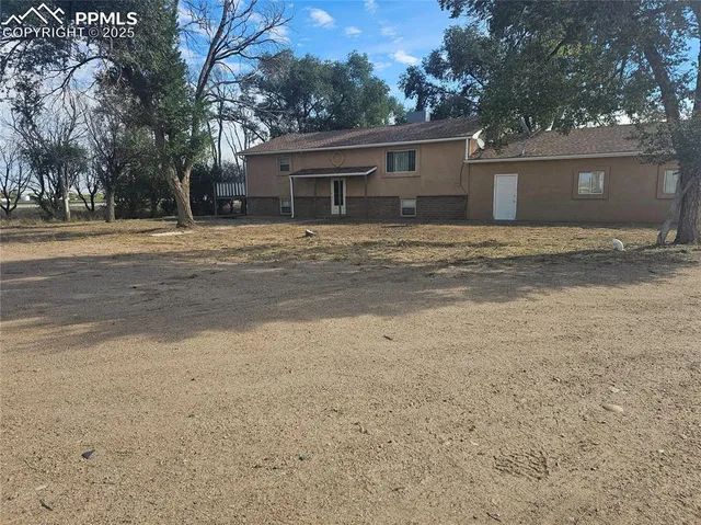 a front view of house with yard and trees