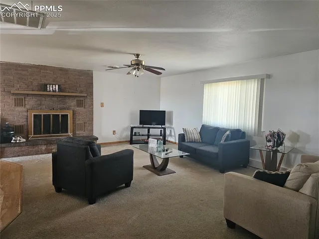 a living room with furniture a fireplace and a flat screen tv