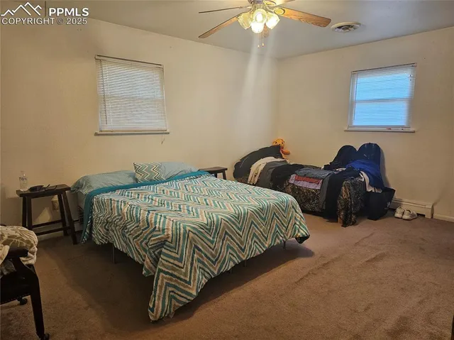 a bedroom with bed and a chandelier