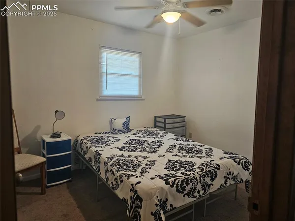 a bed sitting in a bedroom next to a window