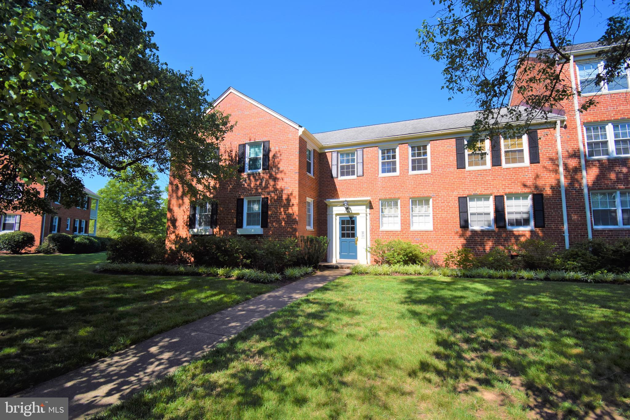 6612 10th Street, Unit B2 Alexandria, VA 22307 - Photo 15 of 26 a view of a brick building next to a yard with big trees