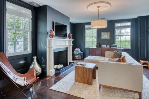 a living room with furniture a window and a fireplace
