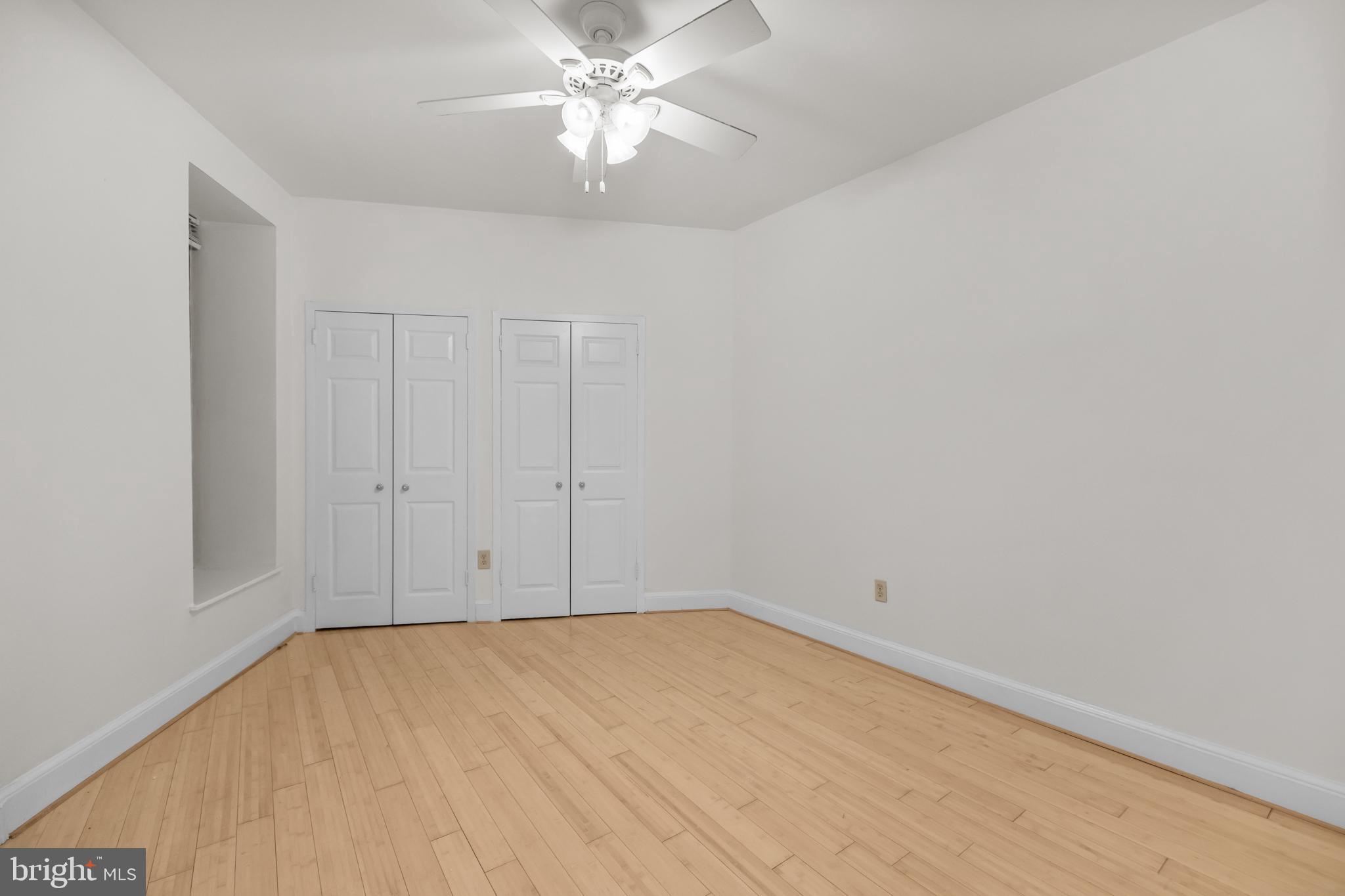 1115 12th Street Northwest, Unit 104 Washington, DC 20005 - Photo 12 of 25 wooden floor in an empty room