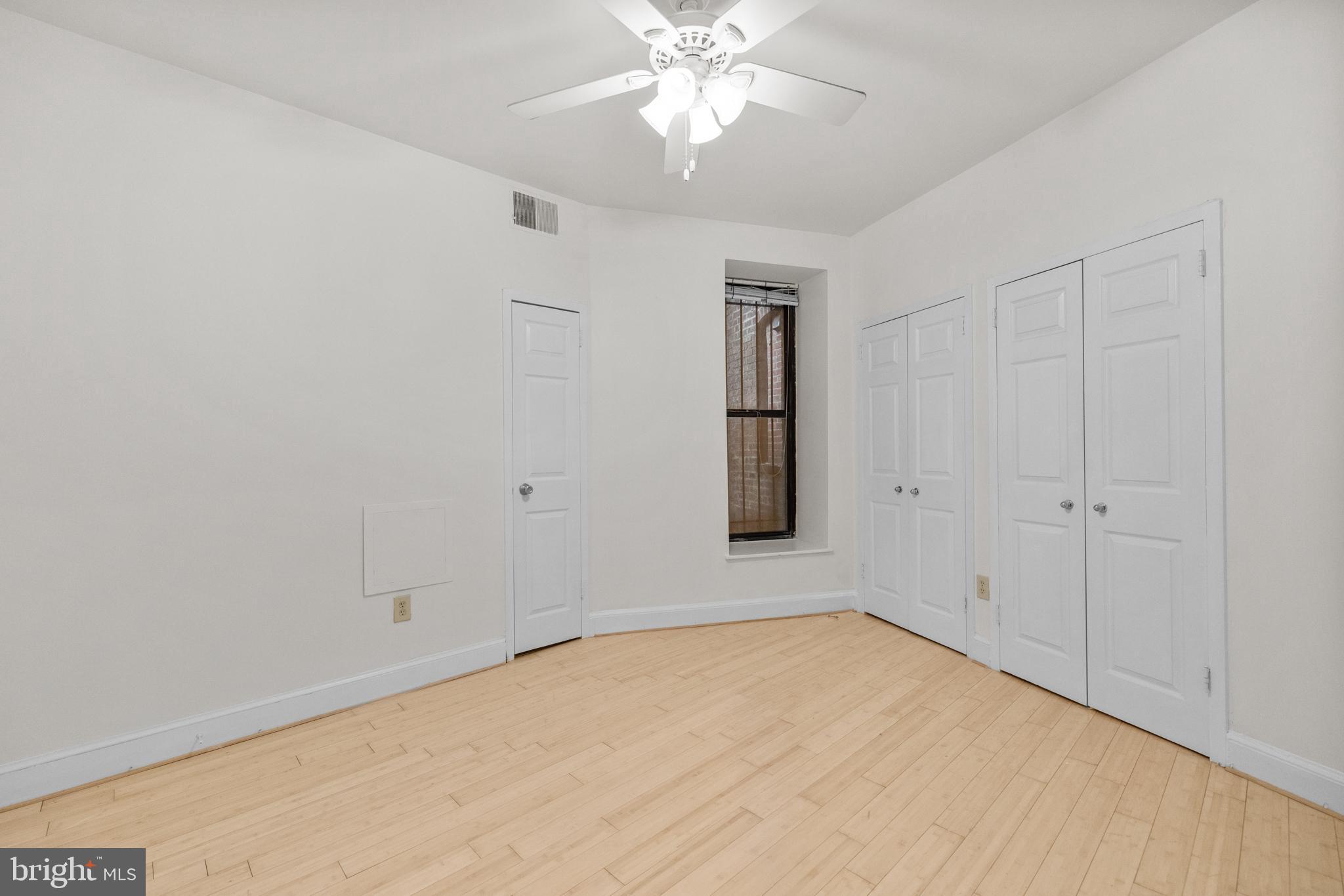 1115 12th Street Northwest, Unit 104 Washington, DC 20005 - Photo 14 of 25 wooden floor in an empty room with a window