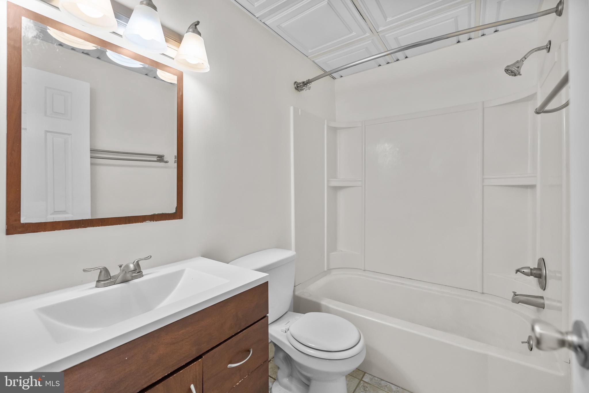 1115 12th Street Northwest, Unit 104 Washington, DC 20005 - Photo 15 of 25 a bathroom with a sink toilet tub vanity and shower