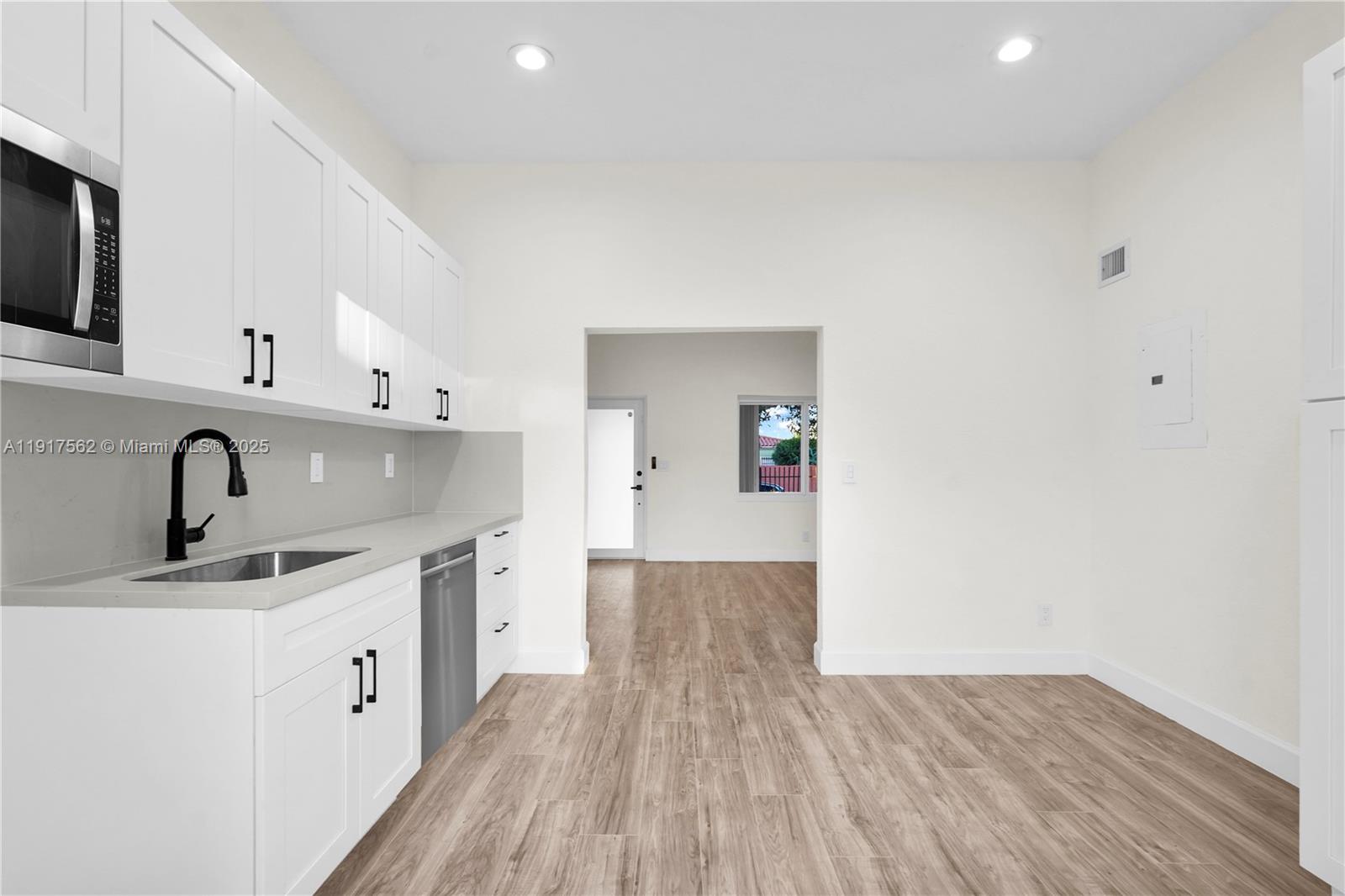 88 Southwest 29th Avenue Miami, FL 33135 - Photo 11 of 30 a kitchen with a sink cabinets and wooden floor
