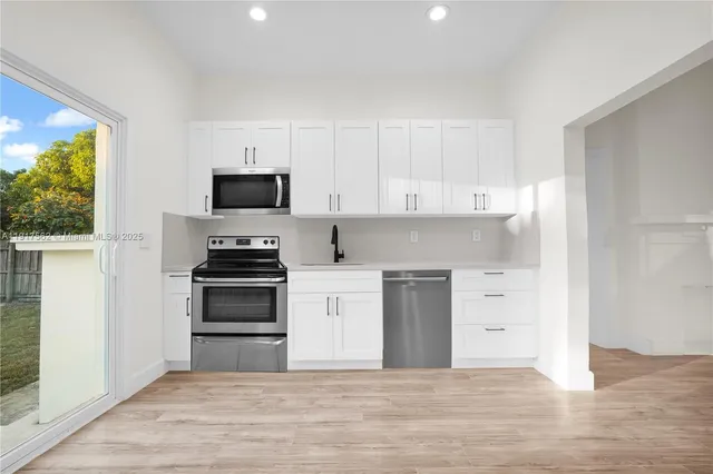 a kitchen with granite countertop a stove and a refrigerator