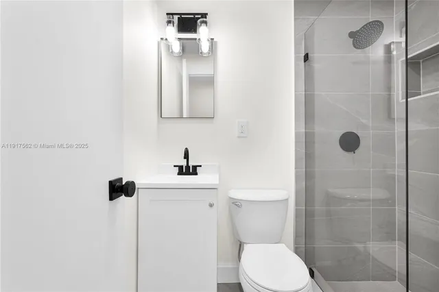 a bathroom with a toilet sink and shower