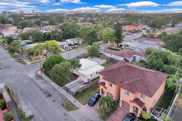 an aerial view of a houses with a street