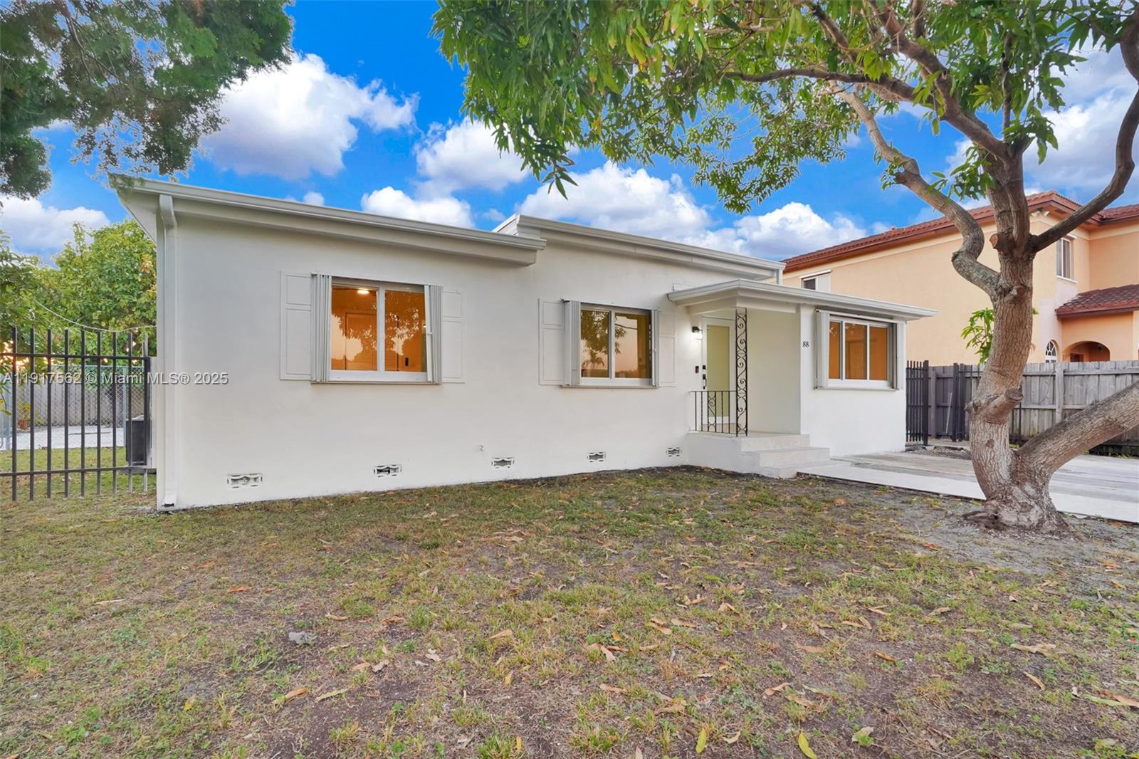 88 Southwest 29th Avenue Miami, FL 33135 - Photo 6 of 30 a view of a house with a tree and a yard