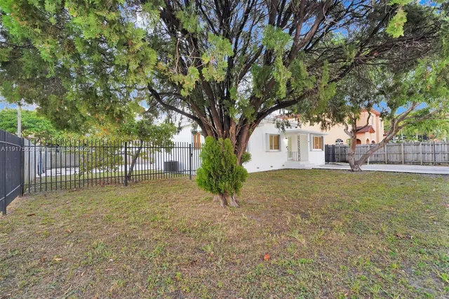 a view of a house with a tree in the background