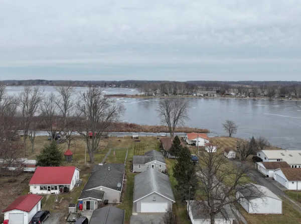 an aerial view of a houses with lake view