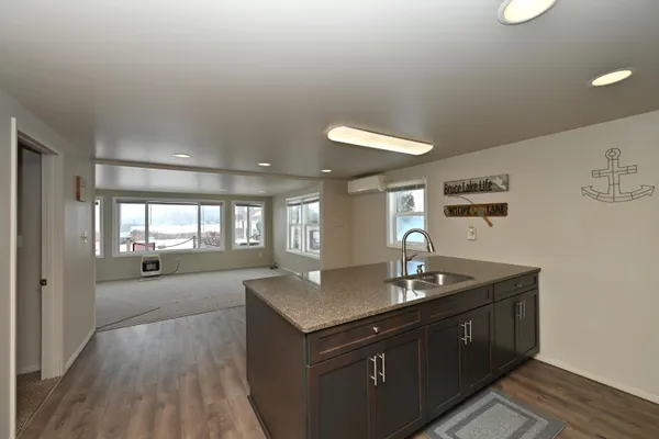 a kitchen with sink refrigerator and window