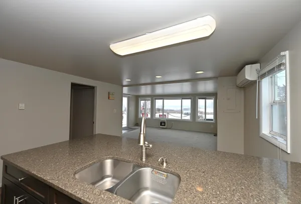 a kitchen with a sink and a large window