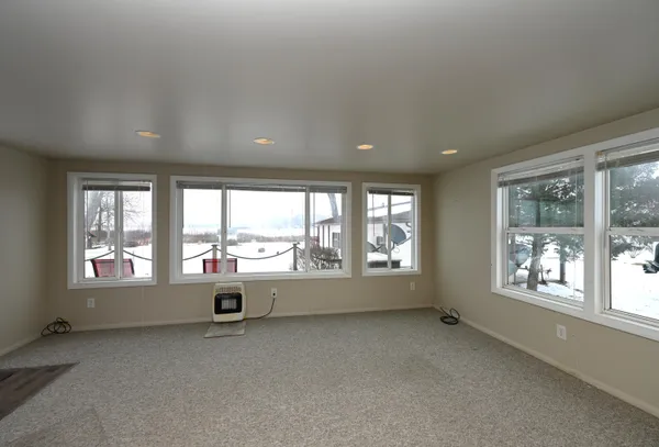 an empty room with large windows