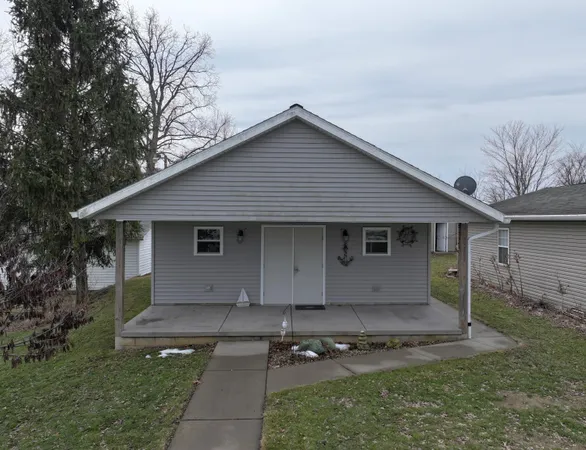 a front view of house with yard and trees