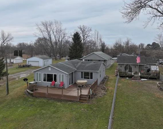 a aerial view of a house with swimming pool and sitting area