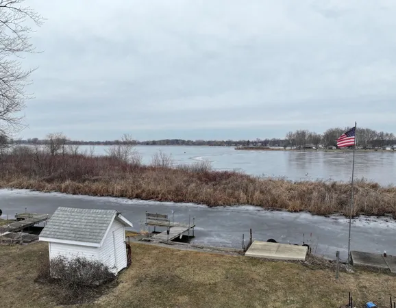 a view of a lake with outdoor space and barbeque oven