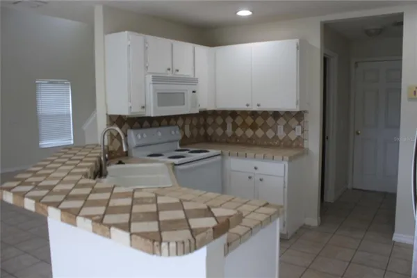 a kitchen with a sink stove and cabinets