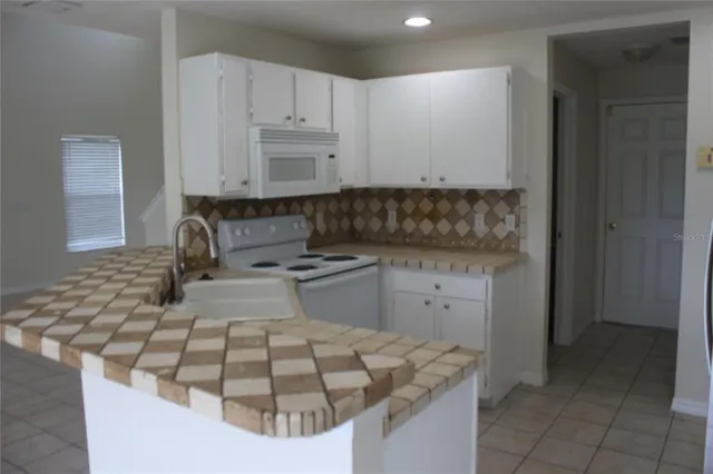 a kitchen with a sink stove and cabinets
