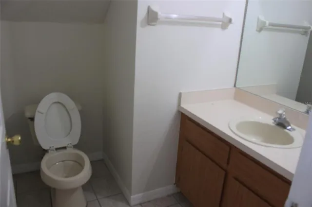 a bathroom with a sink toilet and a mirror