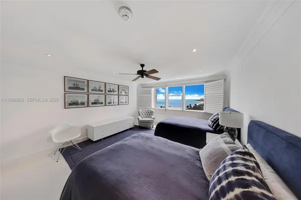 a bedroom with a bed couch and window