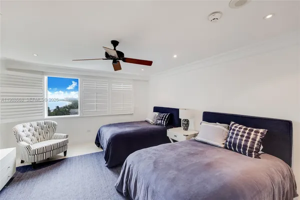 a bedroom with two beds and a couch