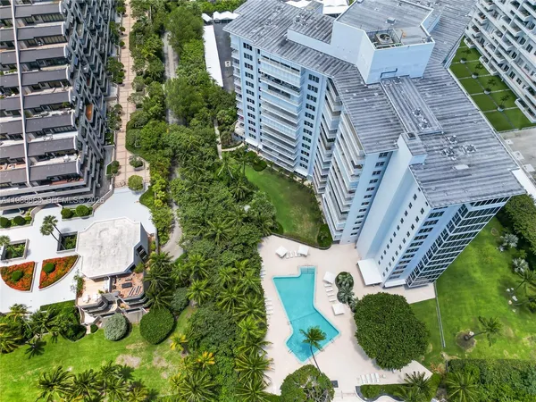 an aerial view of a house with a yard and flowers
