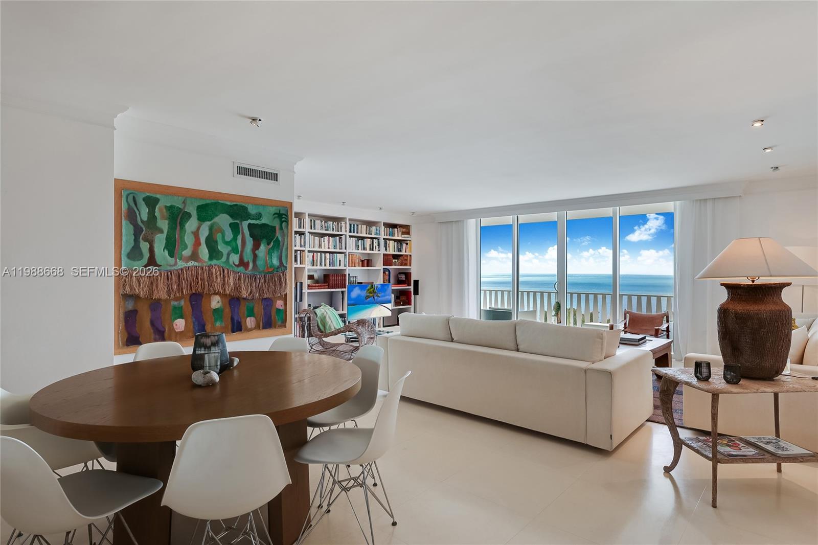 200 Ocean Ln Drive, Unit 1102 Key Biscayne, FL 33149 - Photo 2 of 24 a living room with furniture a flat screen tv and a floor to ceiling window